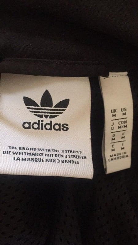 fake adidas jacket with|genuine adidas jacket.